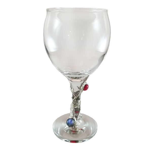 12.5 oz red wine glass designed with two ruby crystal faceted balls and a black mermaid tear with a rainbow of blues and purples when reflecting light. delightful and filled with whimsy.