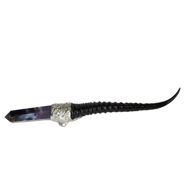 A dark amethyst point with white chevrons inclusions is set on a springbok horn handle. A large white pearl, small white pearl and a small silver pearl adorn the rest. Back view.