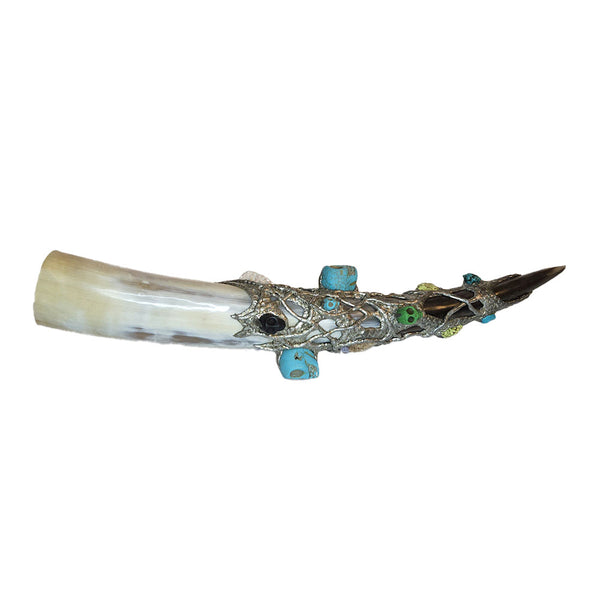 Fit for a pirate king, this large drinking horn has seven craved skulls of turquoise and howlite. Two green and two turquoise nuggets along with two alligator scoots (ridges on the top of a gator. Back view
