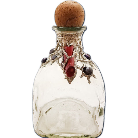 Patron bottle with red coral and black pearls front view