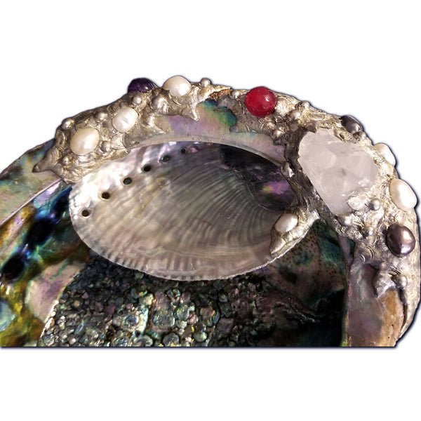 close up of double abalone shell with quartz, pearls and ruby