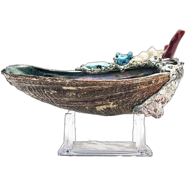 Decorative abalone shell with turquoise stones, coral on a white background side view