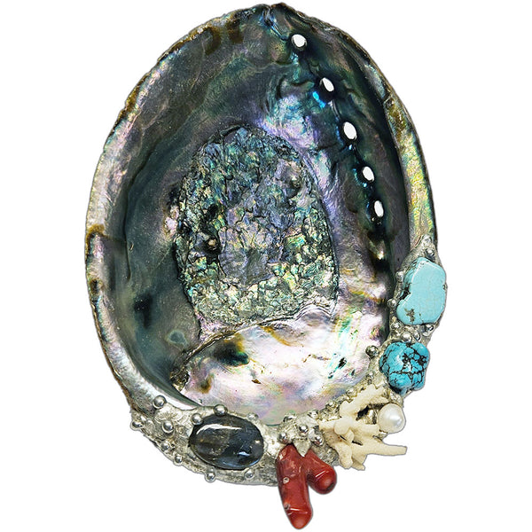 Decorative abalone shell with turquoise, coral, and pearl-like stones on a white background