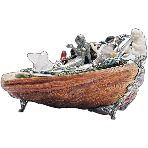 A mermaid rests on a large pink abalone shell, adorned with corals, seashells, gemstones and driftwood side view 2