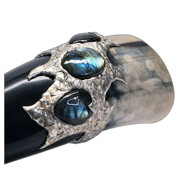 a drinking horn made from steer with three labradorite cabochon two are transformed into hearts close up