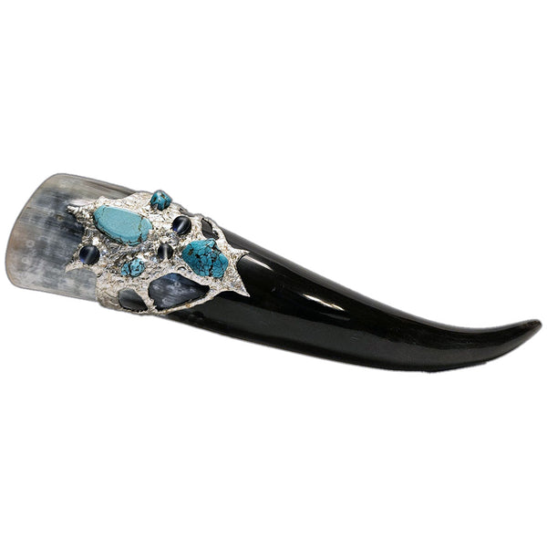 a drinking horn made from steer, turquoise cabochon, a large turquoise nugget and two small turquoise nuggets and three mermaid tears