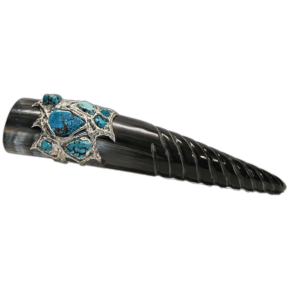 a drinking horn made from steer with a spiral carving at the bottom, two turquoise cabochons, two turquoise nugget and three small turquoise nuggets and three mermaid tears 