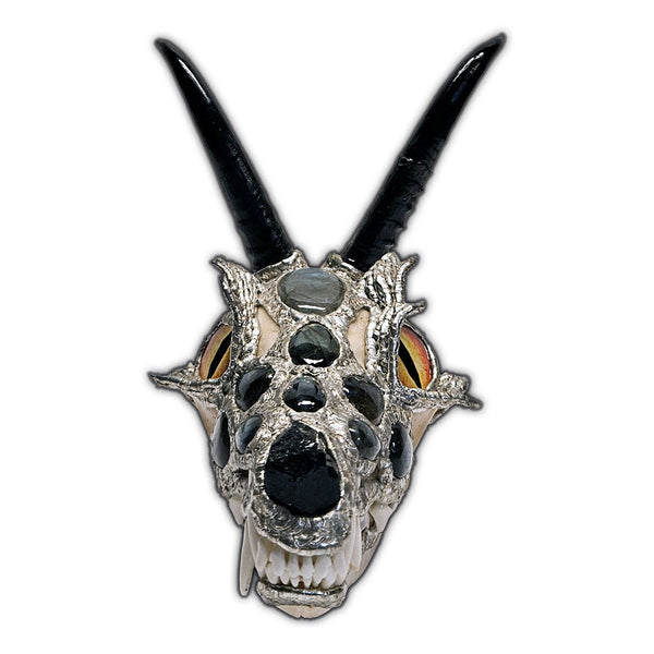A dragon skull is sculpted out of a coyote skull, two springbok horns, eleven labradorite cabochons, glass for eyes, black tourmaline nose