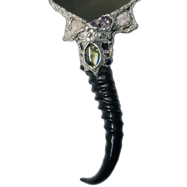 Decorative hand mirror with a blesbok horn handle, labradorite, quartz, amethyst, black pearls and red branch coral front close up view