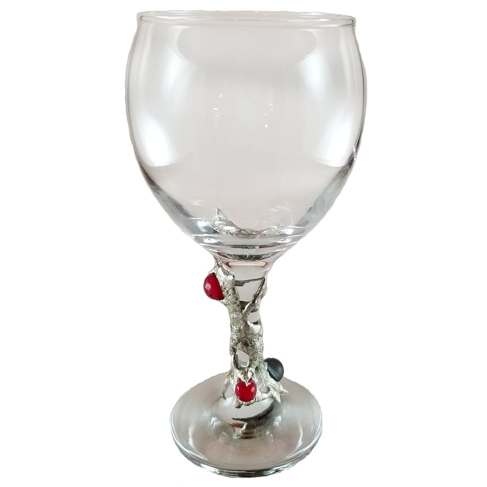 12.5 oz red wine glass designed with two ruby crystal faceted balls and a black mermaid tear with a rainbow of blues and purples when reflecting light. delightful and filled with whimsy. Front view