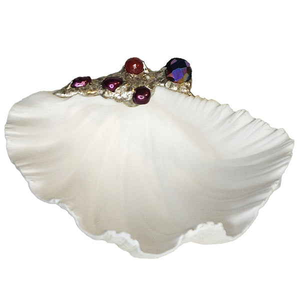 A beautiful china clam shell bowl is decorated with a large titaniumized faceted crystal bead, a ruby crystal faceted ball and three purple pearls. Comes with a leucite stand.