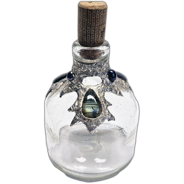 Repurposed bottle decanter adorned with three shimmering labradorite cabochons and three mysterious black pearls—an ocean’s enchantment captured in glass