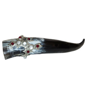 A long drinking horn is set with five large white mermaid tears and seven red faceted fire polished glass beads.  Front view