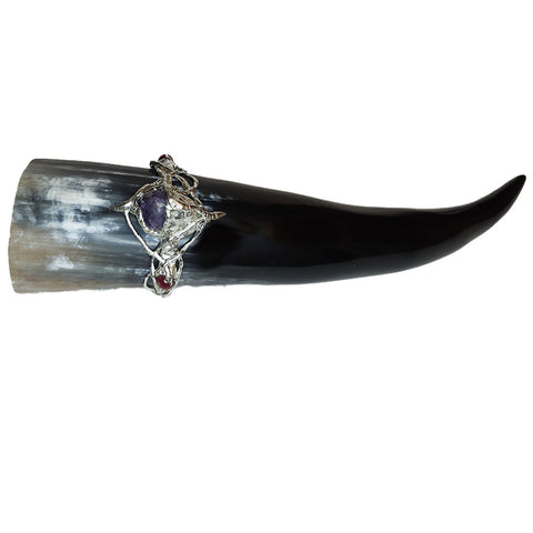 Braided onto this gorgeous drinking horn is an amethyst point and two ruby crystal faceted beads.  front view