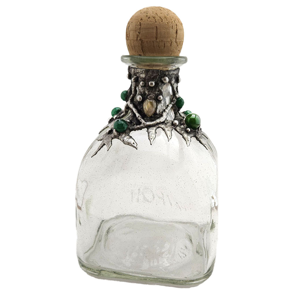 A Patron bottle is decorated with seven emerald crystal faceted beads and a small purple hue labradorite cabochon. Dress up your home bar and bedazzle your guest front view