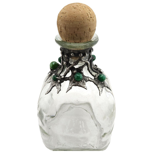 A Patron bottle is decorated with seven emerald crystal faceted beads and a small purple hue labradorite cabochon. Dress up your home bar and bedazzle your guest back view