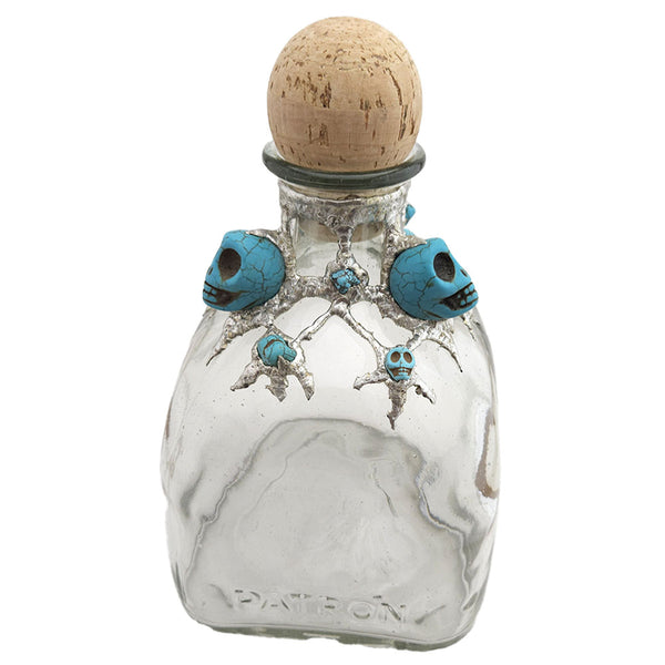 A Patron bottle has been adorned with three large turquoise skulls, three small turquoise skulls and six small turquoise nuggets. Truly a place for your best spirits that is worthy of a pirate king, savvy! Back view