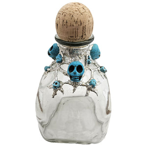 A Patron bottle has been adorned with three large turquoise skulls, three small turquoise skulls and six small turquoise nuggets. Truly a place for your best spirits that is worthy of a pirate king, savvy! Front view