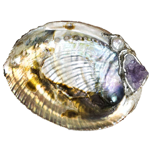 An amethyst cluster is set with a white coin pearl on this abalone shell jewelry bowl.