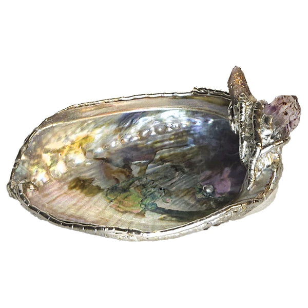 A gem of a red abalone shell adorned with an amethyst spirit/cactus quartz point and an amethyst point. The abalone has a rainbow of color