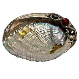 small abalone shell with Tahitian black pearls and a ruby crystal ball top view