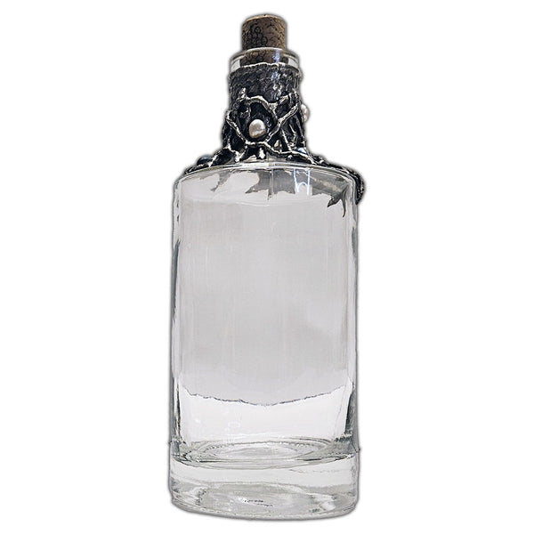 Repurposed rum bottle decanter featuring a silver pirate’s piece of eight at its center, adorned with seven luminous white pearls side view 2