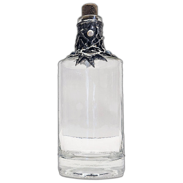 Repurposed rum bottle decanter featuring a silver pirate’s piece of eight at its center, adorned with seven luminous white pearls front view