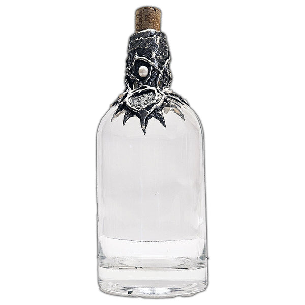 Repurposed rum bottle decanter featuring a silver pirate’s piece of eight at its center, adorned with seven luminous white pearls