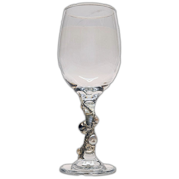 white and black pearls on a white wine glass view 1