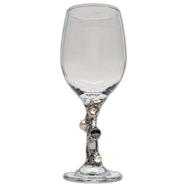 white and black pearls on a white wine glass view 2