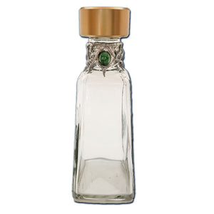 1800 bottle with emerald cabochon and black pearls front view.