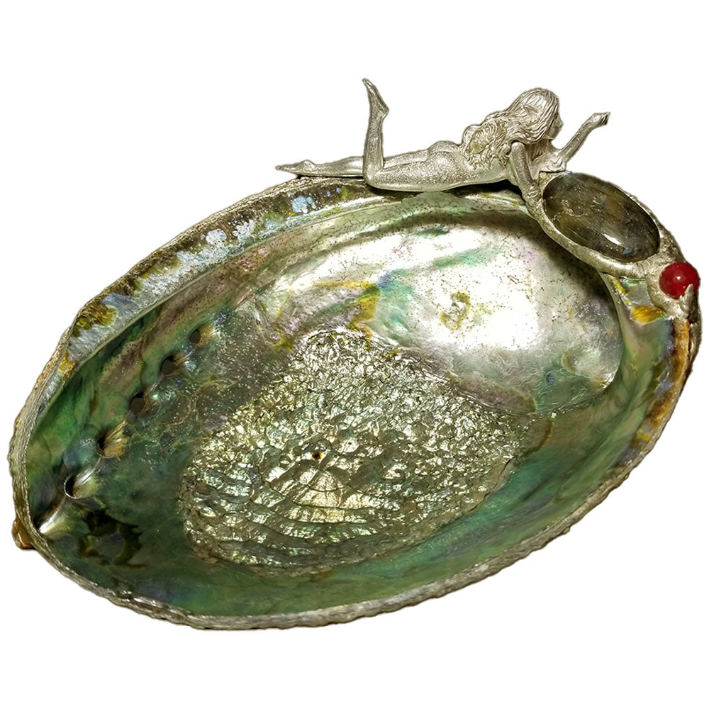 A fairy lays on a beautiful green abalone shell with labradorite, ruby and a double white pearl.