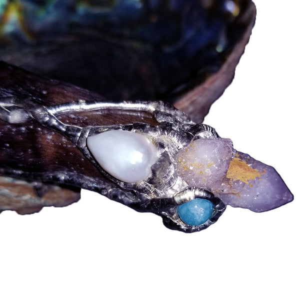 close up of amethyst spirit quartz, aquamarine ball and large white pearl