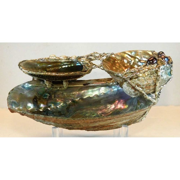 Front view of our double abalone shell bowl with black and white pearls.