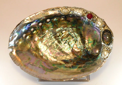 Blue-green abalone shell bowl decorated with a carved labradorite cabochon with a rainbow of color. Two double white pearls and two large white pearls. Leucite stand included.
