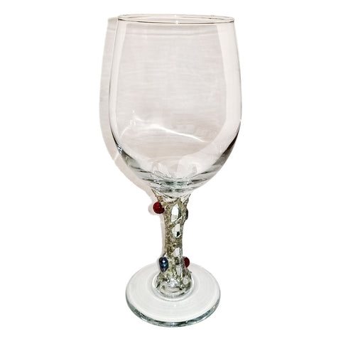 white wine glass with two rubies and two black Tahitian pearls. A view